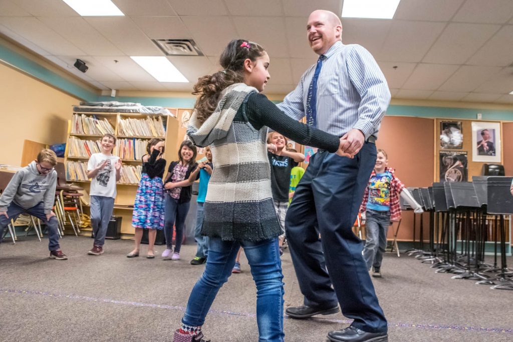 Fatima's Grade 3 class did a game where the students form a circle and spin a partner around in the middle. Fatima gives Principal Dave Foster a spin. (Richard McGuire photo)