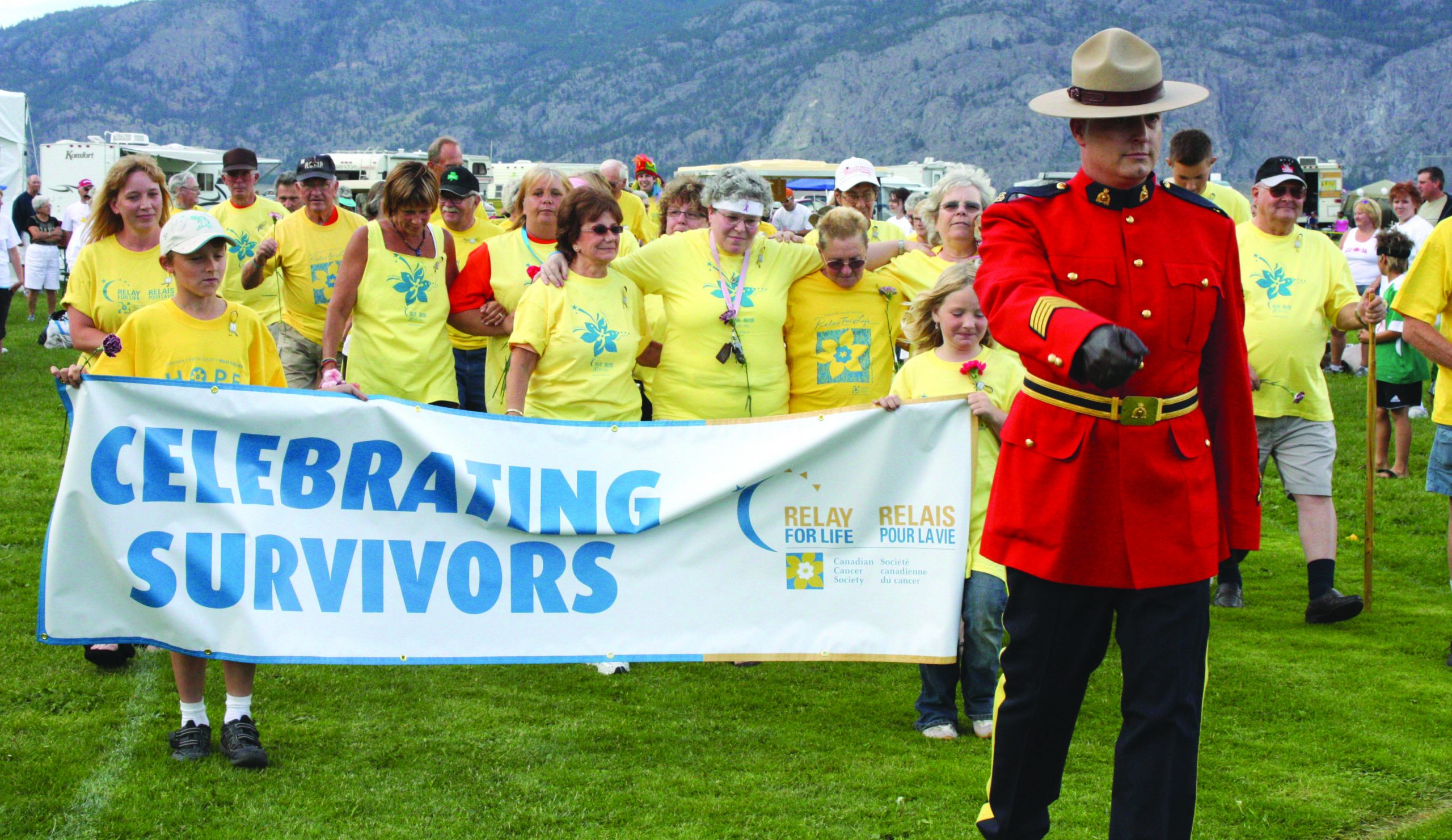 relayweb Staff Sgt. Kurt Lozinski, commander of the Osoyoos-Oliver RCMP detachment, leads a group of cancer survivors to kick off the fifth annual Canadian Cancer Society Relay for Life at Desert Park on June 20. Photo by Paul Everest