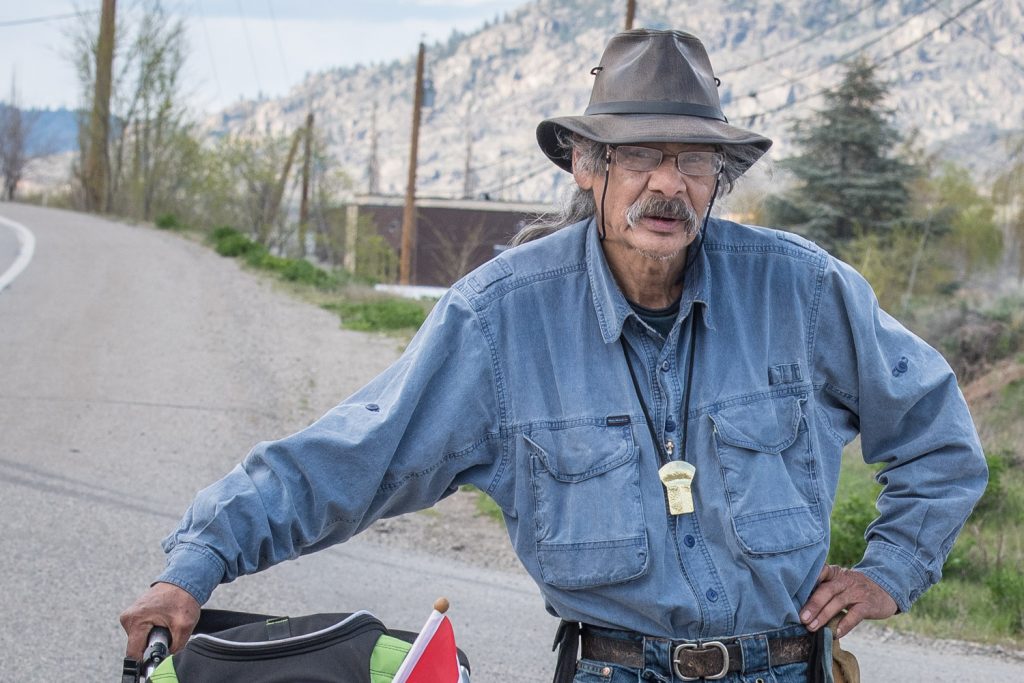 Robin Edgar Haworth is walking from Penticton to Ottawa with his Australian Shepherd dog Koda to raise awareness about a number of "wrongs and injustices" that concern him. He walked down Highway 97 to Osoyoos on Saturday before heading off east up Anarchist Mountain. His campaign is called Right the Wrong. (Richard McGuire photo)