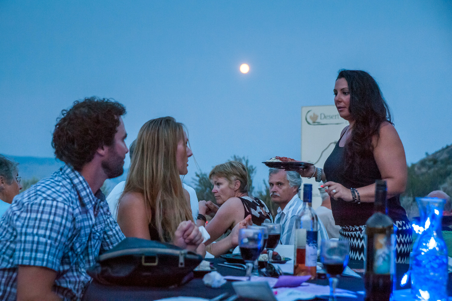 As a full moon rises in the sky, guests dine at the plaza at the Osoyoos Desert Centre on Saturday night. The official full moon the following night is called a supermoon because the moon was at its closest orbit to the earth, making it appear larger. (Richard McGuire photo)