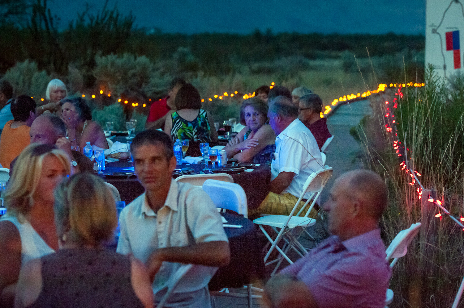 Guests socialize after dinner in the plaza at the Osoyoos Desert Centre at Romancing the Desert on Saturday night. The event is a fundraiser for the Osoyoos Desert Society. (Richard McGuire photo)
