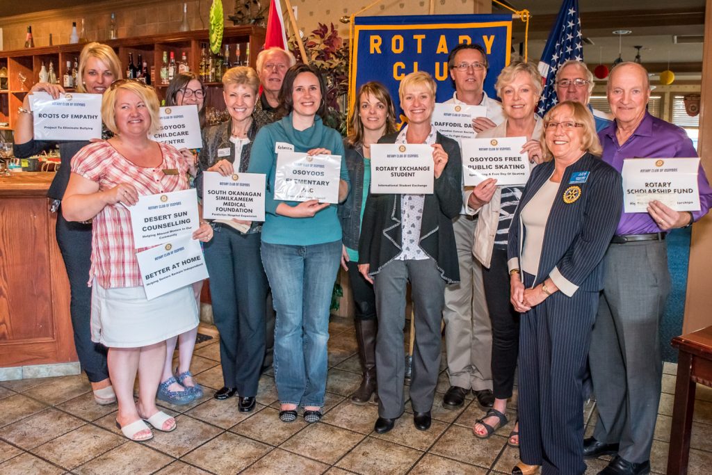The Rotary Club of Osoyoos handed out a number of cheques to community organizations last Wednesday at a joint social event with the South Okangan Chamber of Commerce. Representing recipients from left are: Marieze Tarr (Roots of Empathy anti-bullying project); Tamara Aspell (Desert Sun Counselling and Better at Home); Chrissie Coffin (Osoyoos Childcare Centre); Janice Perrino and John Moorehouse (South Okanagan Similkameen Medical Foundation); Rebecca Bayda and Lisa Kunz (Osoyoos Elementary School Parent Advisory Council); Karen Somerset (Rotary Exchange Student); Philip Jansen (Daffodil Dash and Canadian Cancer Society); Sue McKortoff (Osoyoos Free Public Skating); Judy Miller-Bennett (Rotary president); Ron Leigh (Osoyoos Concert Series); and Harold Cox (Rotary Scholarship Fund). (Richard McGuire photo)