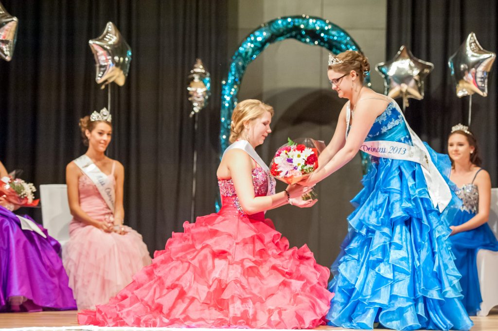 Viveka Jensen (standing), an outgoing Osoyoos princess, passes a bouquet of flowers to new princess Amara Leeson. (Richard McGuire photo)