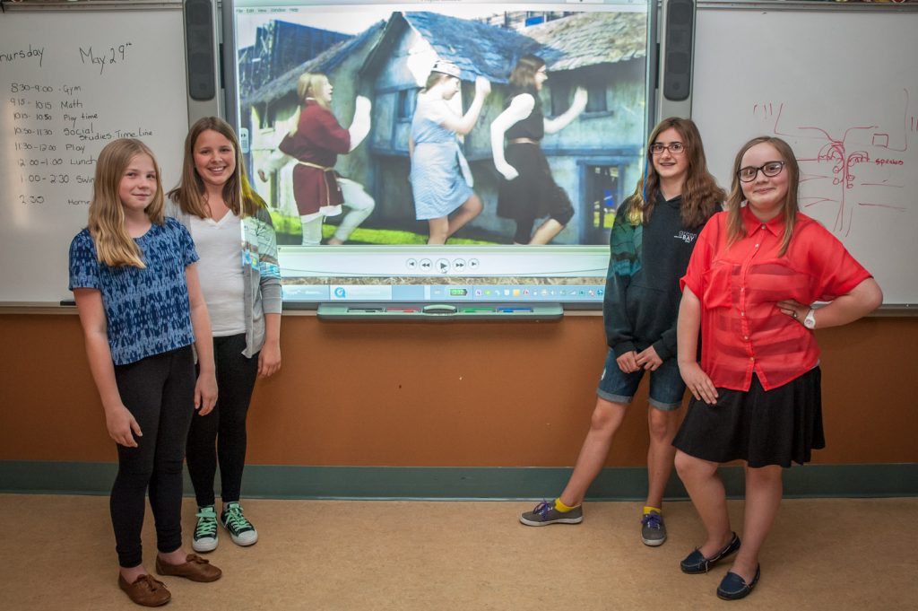 Students (from left) Holly Duguid, Rheanna Harfman, Patricia Bratton and Emma Mandziuk show the video they made about the Carolingian Empire of early 9th century Europe. The girls and their classmates acted and sang and used a video green screen to superimpose backgrounds. (Richard McGuire photo)