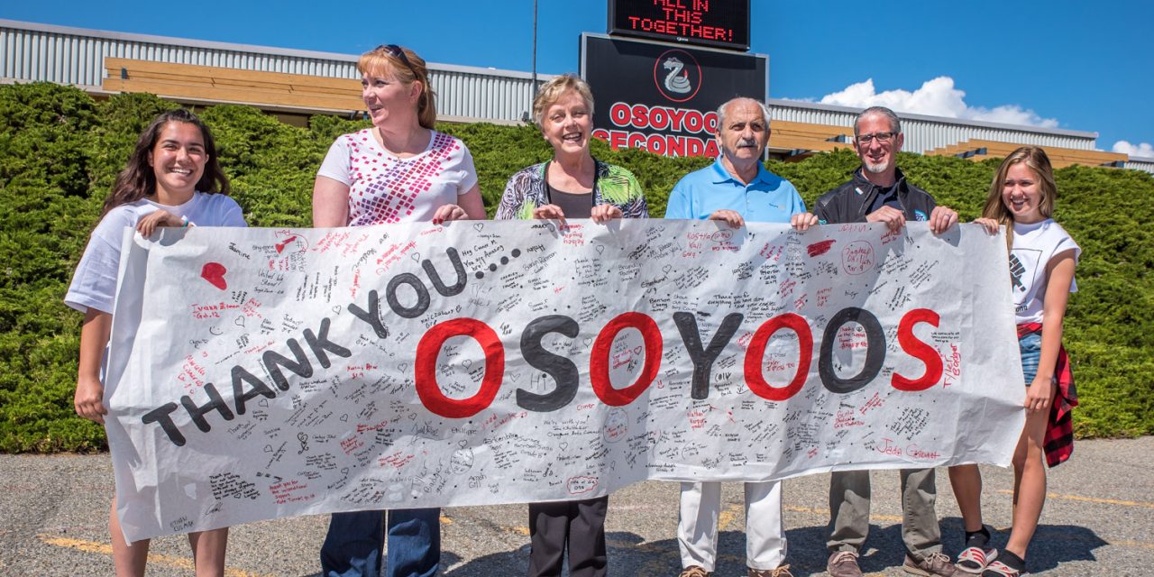OSS students present banner thanking community for support