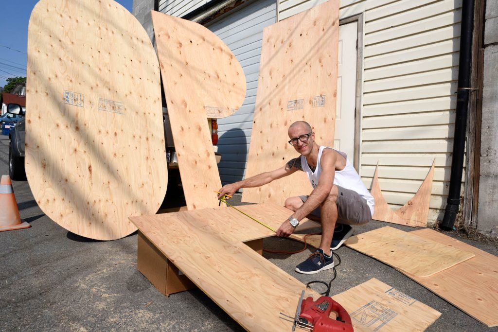 Jamie Elder, owner of Unity Osoyoos, is making a giant “OPEN” sign to welcome students back to Osoyoos Secondary School. The letters look like they will rival the “HOLLYWOOD” sign that sits above Los Angeles. (Richard McGuire photo)