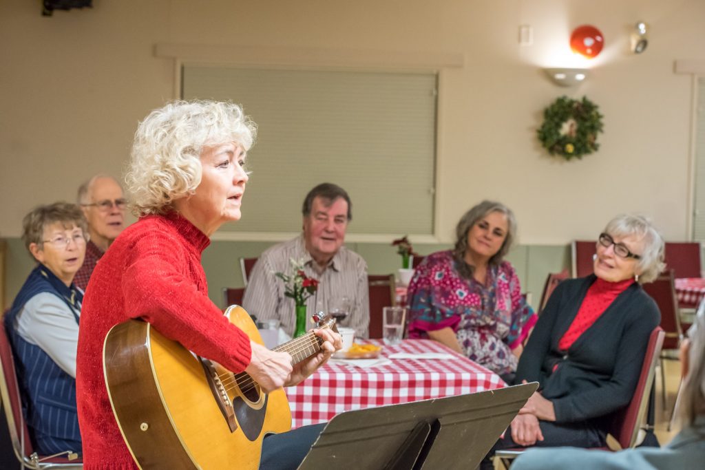 Alberta singer Marina gave a concert at the Osoyoos Senior Centre on Sunday evening on her way through to Vancouver. She's just returned from a 25-city busking tour. Marina once played in a band in Hinton, Alta., with Ted Osborne, past president of the Osoyoos Seniors Centre Association, who is pictured in the background to her immediate right. She opened with an unplugged, coffee house style concert before getting up on the stage for some amplified songs. (Richard McGuire photo)