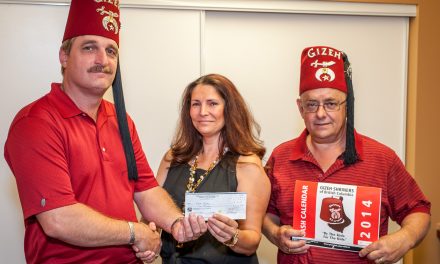 Shriners present cheque to winner of calendar draw