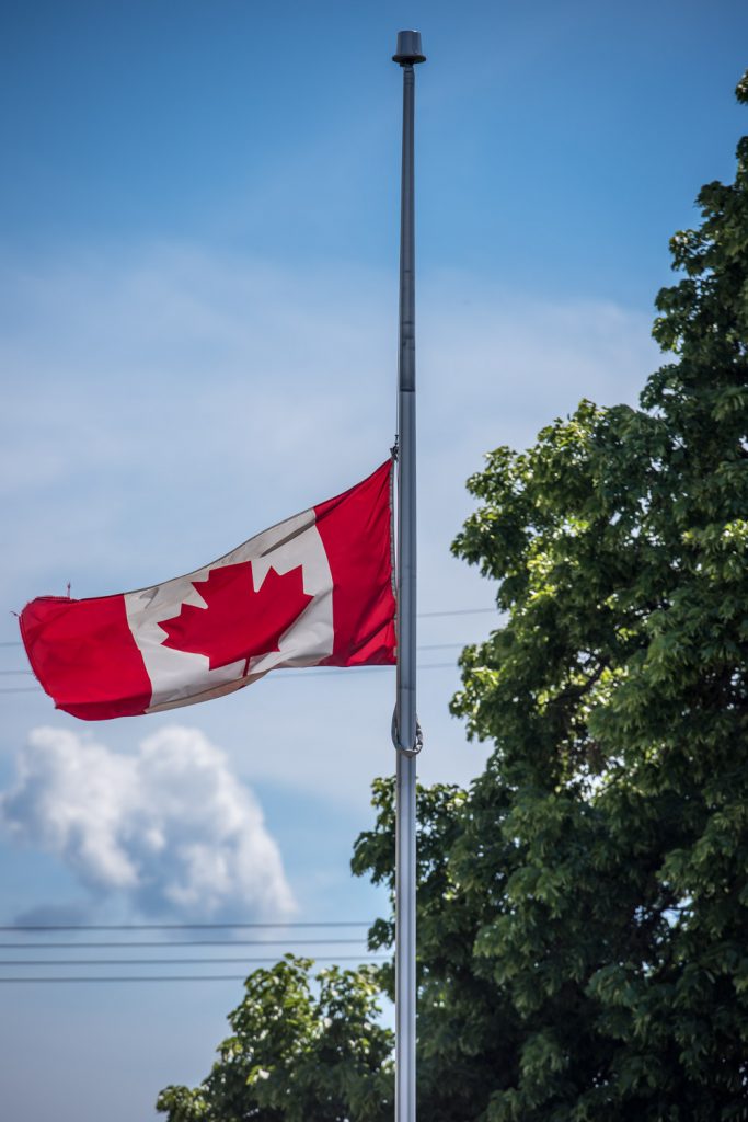 The flags outside the Osoyoos town hall were lowered to half mast last week in tribute for former mayor and MLA John Slater, who died last Wednesday. (Richard McGuire photo)