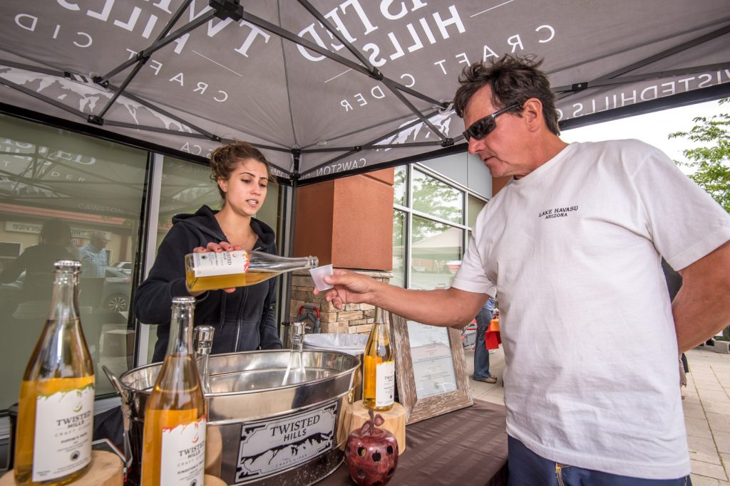 Slow food is the opposite of fast food -- it uses handcrafted, organic and generally wholesome ingredients. For the fourth year in a row on Sunday slow food vendors held a market in front of the Watermark Beach Resort. Pictured here, Kaylen Madeira, owner and cider maker at Twisted Hills in Cawston, pours a sample of cider for Doc Kuryluk, owner of Island View RV Resort in Osoyoos. The Annual Market of Taste by Slow Food Thompson Okanagan was held in conjunction with the Devour! Food Film Festival, which is making a cross-country stopover in the Okanagan Wine Country this year. (Richard McGuire photo)