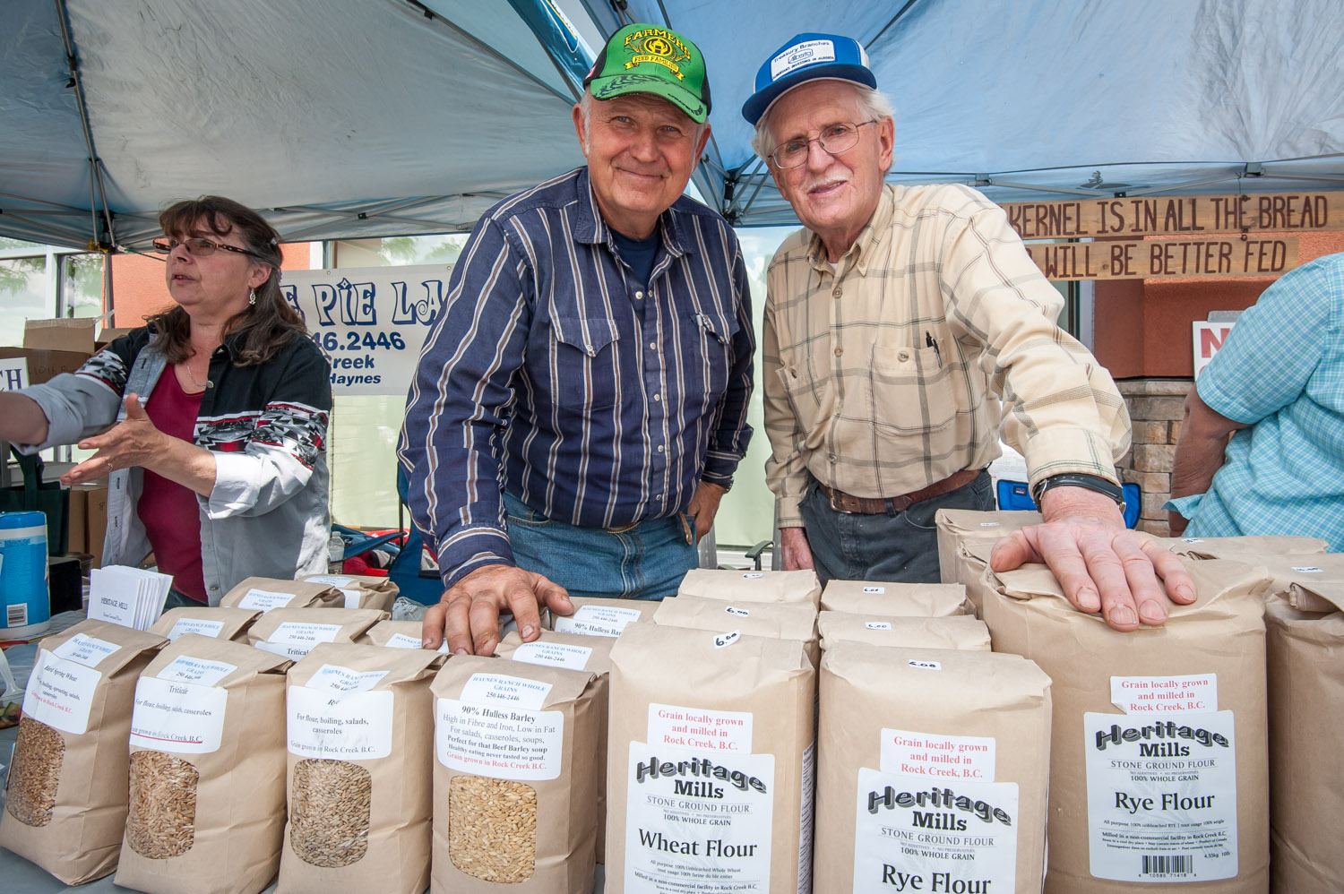 Jamie Haynes, left, grows heritage varieties of grain on his farm near Rock Creek and Melvin Steinke (right) mills it at Heritage Mills. If not for people like Haynes and Steinke, many of these heritage varieties would disappear. They had a booth at Market of Taste, which was part of the Slow Food Thompson Okanagan foodie extravaganza Sunday at the Watermark Beach Resort. (Richard McGuire photo)