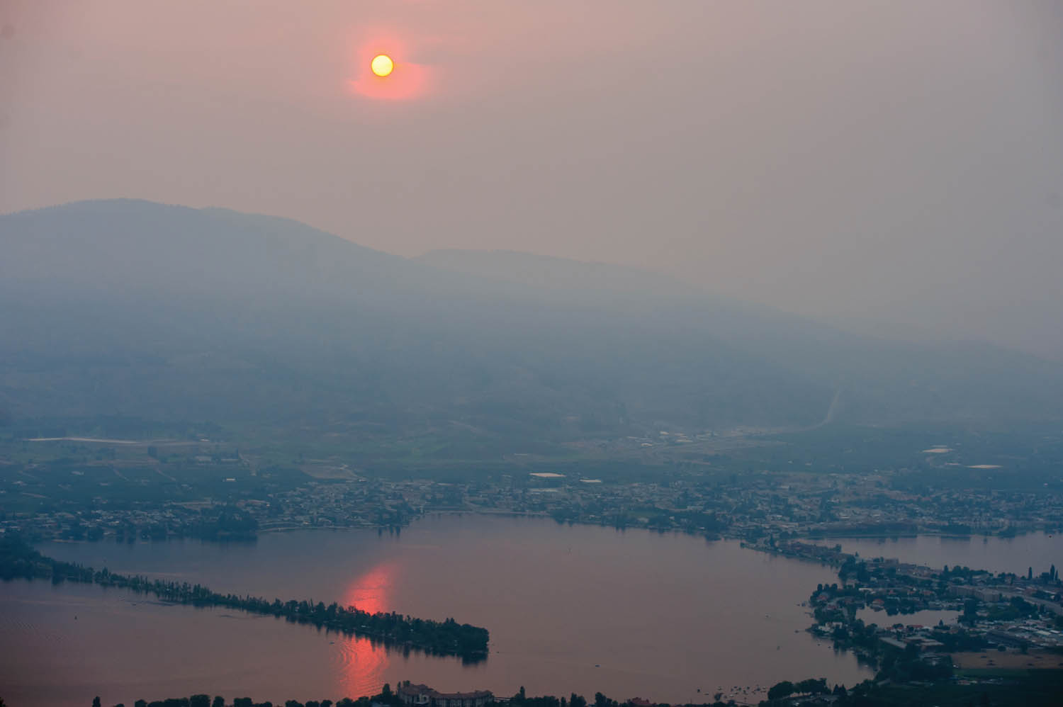 The sun glows like an orange ball as it lowers through smoky atmosphere above Osoyoos. A wildfire smoke advisory is in effect for much of the southern Interior including Osoyoos. (Richard McGuire photo)