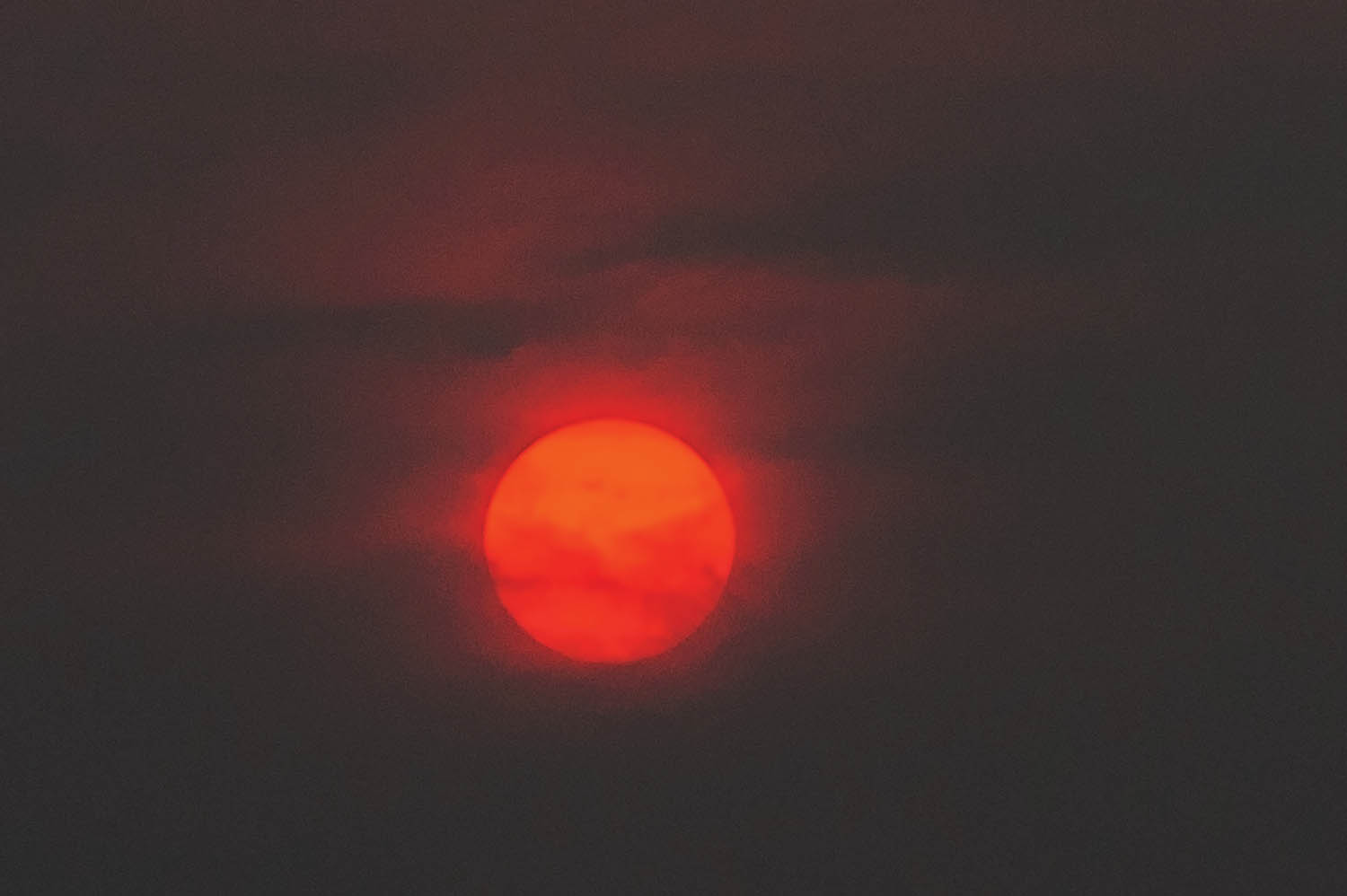 The sun glows like an orange ball as it lowers through smoky atmosphere above Osoyoos. A wildfire smoke advisory is in effect for much of the southern Interior including Osoyoos. (Richard McGuire photo)