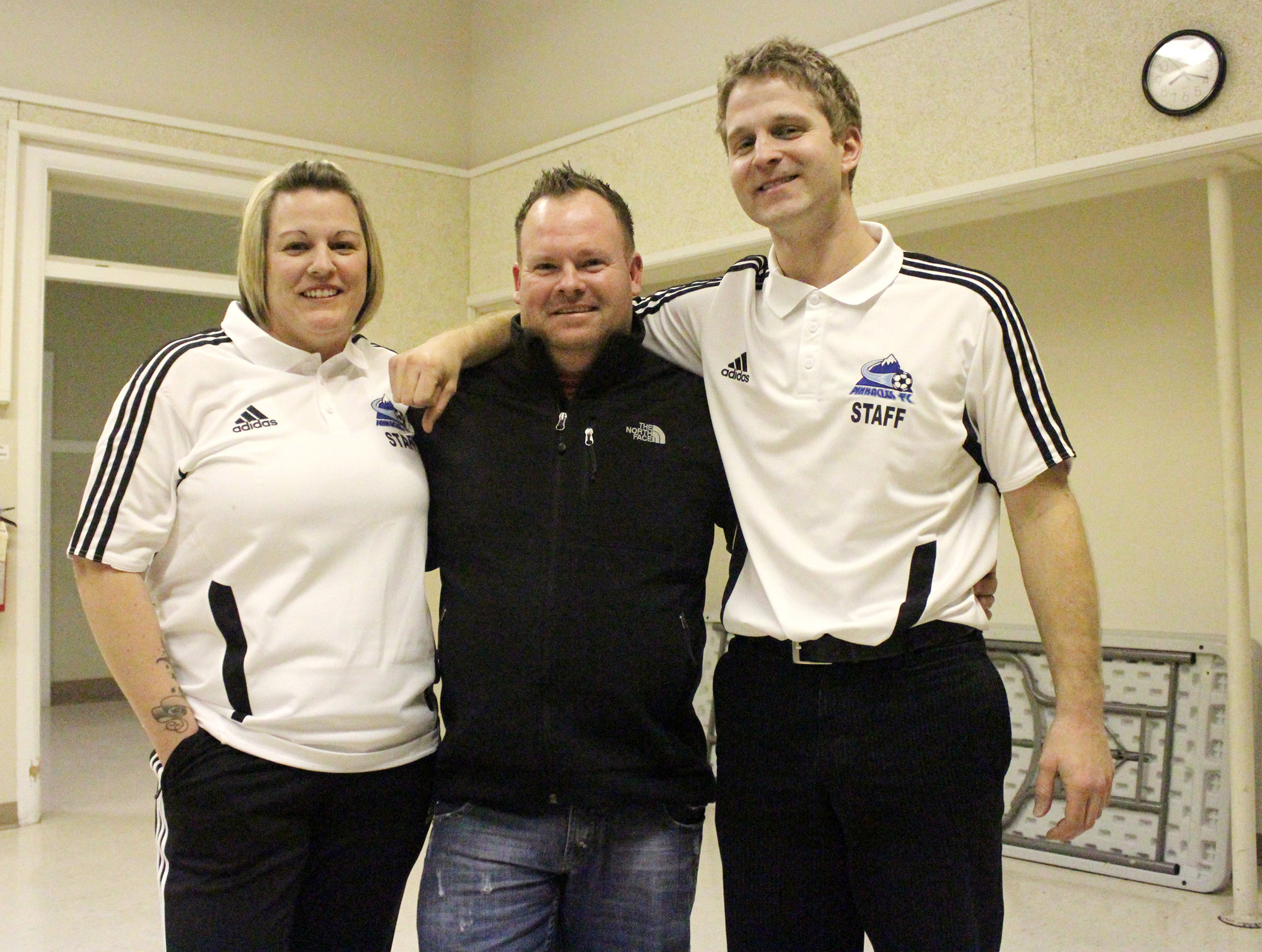 Jill Price (left), Justin Price (centre) and Ezra Cremers stand together after the South Okanagan Youth Soccer Association's town meeting last week. SOYSA held a town meeting to introduce residents to this year's improved program, new staff, and finally, to allow people to get a jump on early registration. Photo by Mathew White