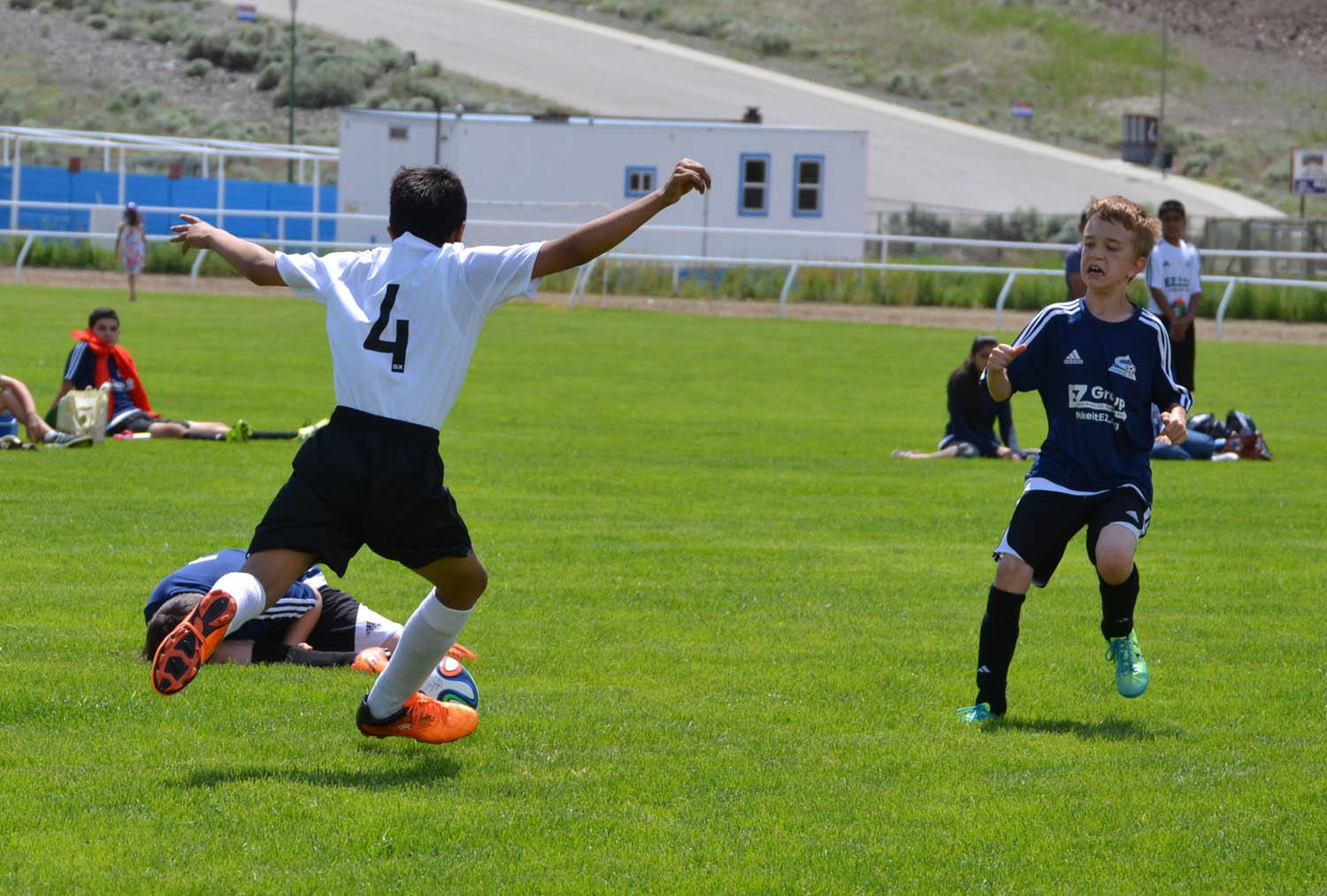 Osoyoos’ Jaspartap Takher blasts a clearing ball past a Pentiction forward. (Trevor Nichols photo)