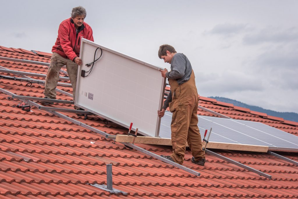 Roger Huber (left) and his son Franco were installing solar panels last week on the home of Jerry McKay and Nancy Fath. The couple were influence by neighbour Paul McCavour who installed panels on his home last year and has become an evangelist for solar energy. (Richard McGuire photo)