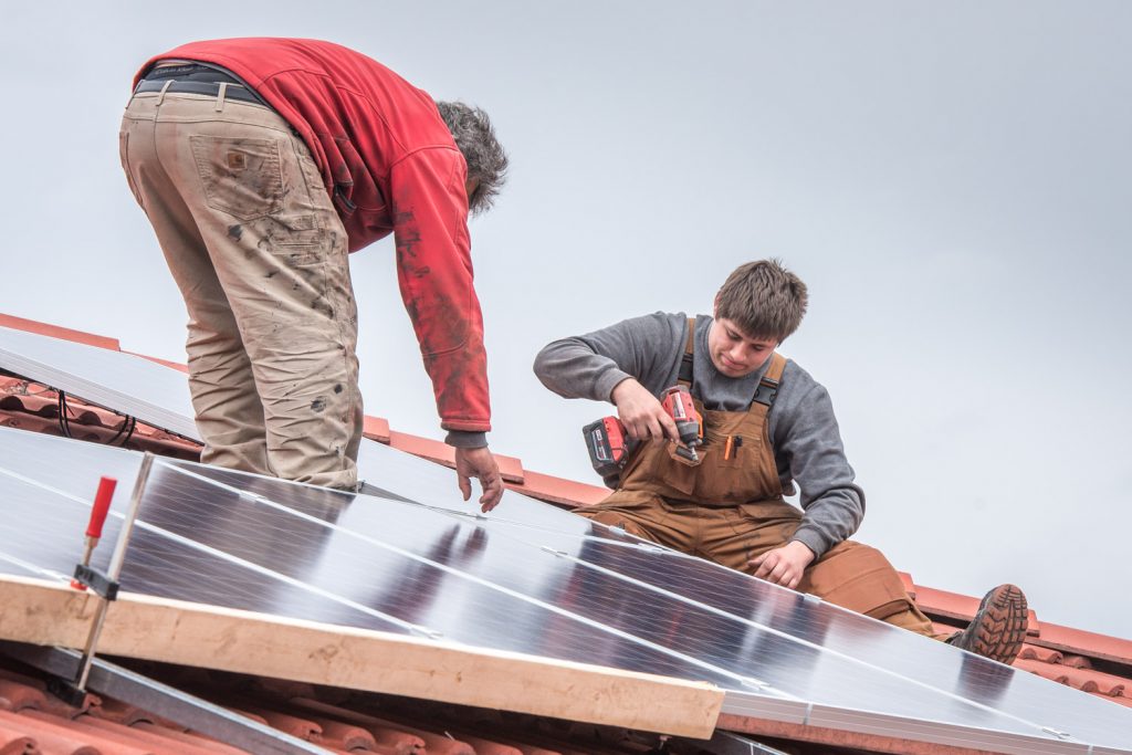 Roger Huber (left) and his son Franco were installing solar panels last week on the home of Jerry McKay and Nancy Fath. The couple were influence by neighbour Paul McCavour who installed panels on his home last year and has become an evangelist for solar energy. (Richard McGuire photo)