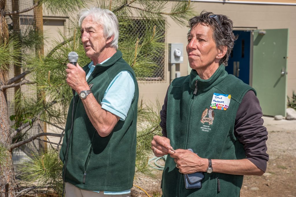 Dave Whitton, chair of the SORCO board of directors, greets guests at the raptor rehabilitation centre's open house on Sunday. With him is Dale Belvedere, who took over as manager in March. The South Okanagan Rehabilitation Centre for Owls (SORCO) takes in other raptors that are injured and releases them after treatment. Normally the centre is not open to the public and efforts are made to keep the birds' contacts with humans to a minimum. (Richard McGuire photo)