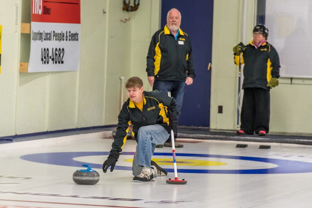 Kyle Sanderson of Oliver lets go of his rock in the Special Olympics mini bonspiel held in Oliver on Saturday. Two teams from South Okanagan Special Olympics faced a visiting team from Princeton in this annual event. (Richard McGuire photo)