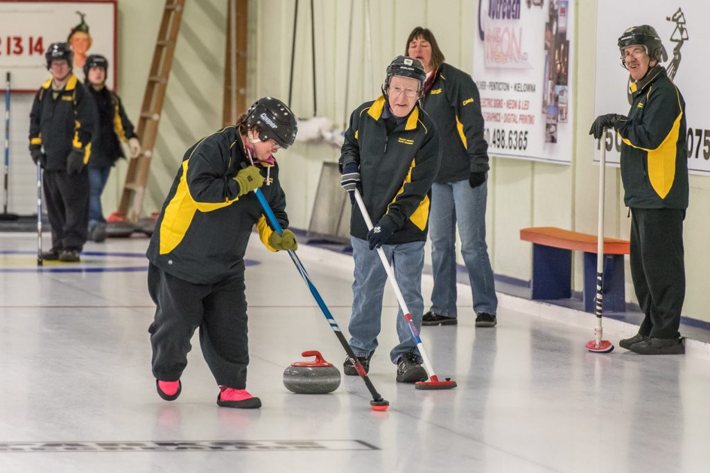 Angela Flannigan (left) and Dave Causley, both of Oliver, sweep the ice during a curling match between two South Okanagan Special Olympics teams. The game was part of an annual three-game mini bonspiel in which the local Special Olympians faced a team from Princeton. (Richard McGuire photo)