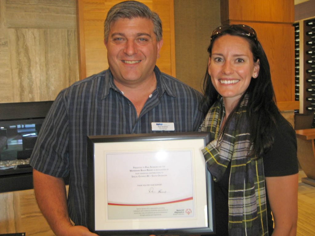 Paul Scanlon, hotel manager at Watermark Beach Resort, received a plaque expressing thanks from Reanne Holden, manager, community development of Special Olympics for the Thompson-Okanagan. (Photo supplied)