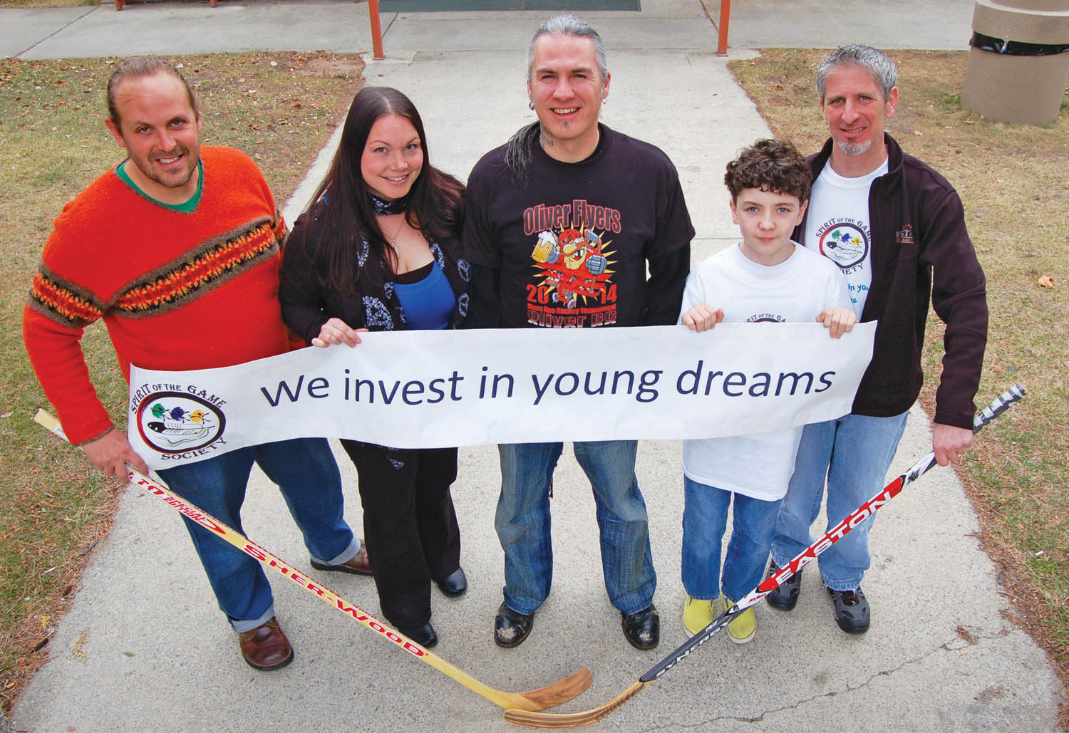 Many people supported the Spirit of the Game Society fundraiser at the Oliver arena last weekend during the Flyers hockey tournament. Shown from left are Orion Kendrick, Jamie Johnson, Terry Baptiste, Jacob Campol and Mike Campol, who chairs the Society’s board of directors. (Lyonel Doherty photo)
