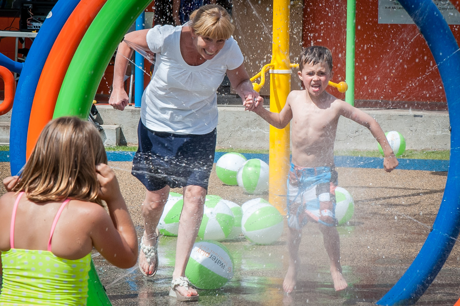 Charlotte King, 10, is surprised by a bolt of water as she tried to fire a cannon at the Osoyoos Splash Park. In July the Town of Osoyoos held a 'Family Splash Day.' The park is now in its third year. (Richard McGuire photo)