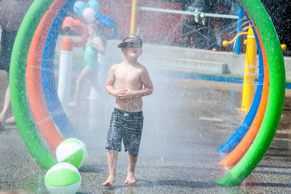 A boy walks through hoops that spray water to cool off at the Osoyoos Splash Park, which officially opened Friday, June 6. (Richard McGuire photo)