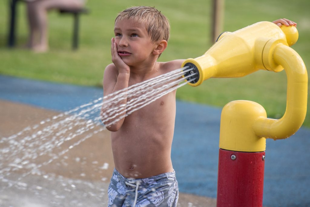 Hudson Warne, 6, of Calgary looked lost in thought as a played with a water cannon last Wednesday at the Osoyoos Splash Park. The occasion was "Family Splash Day," and event organized by the town with refreshments provided by AG Foods. (Richard McGuire photo)