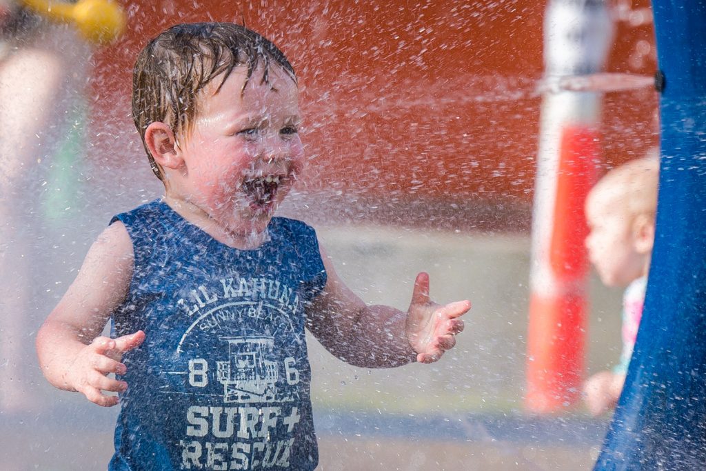 Little Ronan Byrne, two and a half, from Cawston, was delighted by the spray of water at the Osoyoos Splash Park last Wednesday and just kept returning for more. The occasion was "Family Splash Day," and event organized by the town with refreshments provided by AG Foods. (Richard McGuire photo)