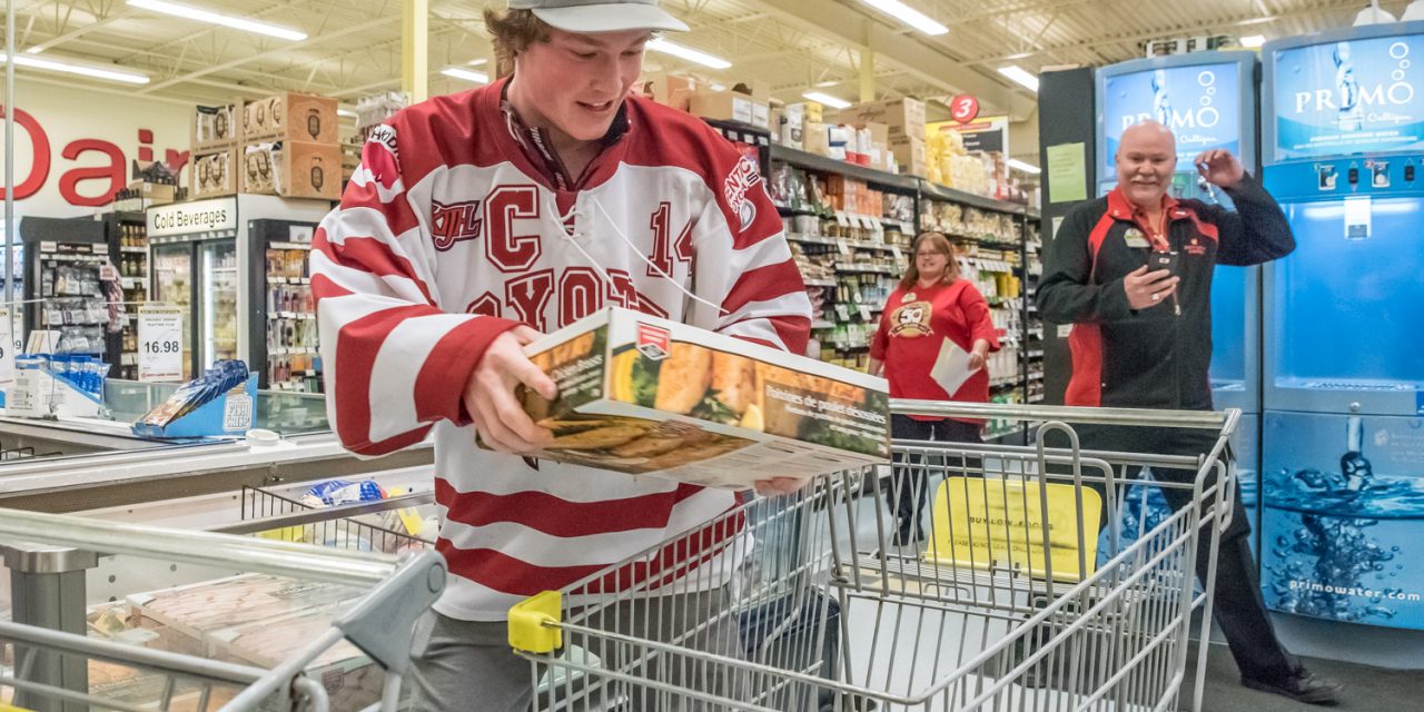 Two women fill their freezers after winning grocery sprees at local stores