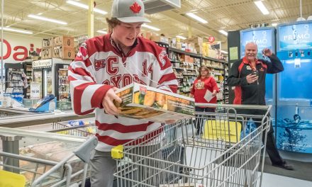 Two women fill their freezers after winning grocery sprees at local stores