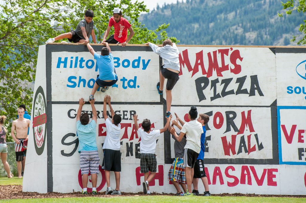 Two teams storm the wall at the conclusion of Osoyoos Secondary School's Storm the Wall event. (Richard McGuire photo)