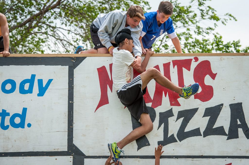 Students above and below the wall helped their teammates complete the climb. (Richard McGuire photo)