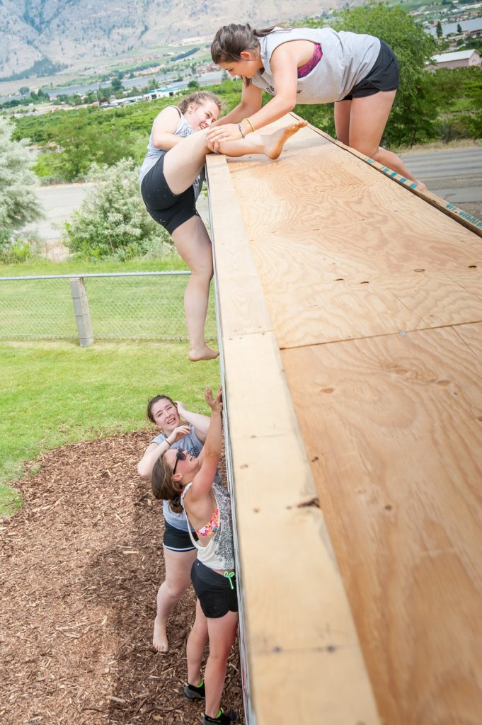 Students above and below the wall helped their teammates complete the climb. (Richard McGuire photo)