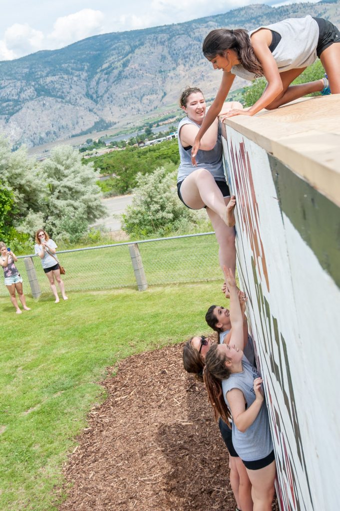 Students above and below the wall helped their teammates complete the climb. (Richard McGuire photo)