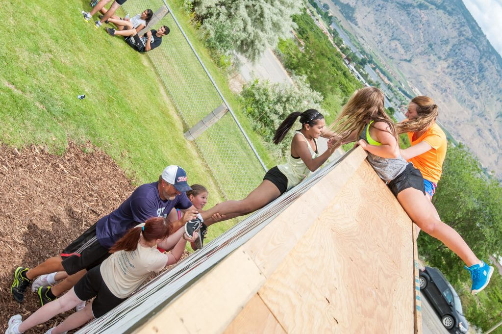 Students above and below the wall helped their teammates complete the climb. (Richard McGuire photo)