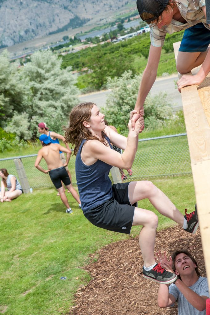 Students above and below the wall helped their teammates complete the climb. (Richard McGuire photo)