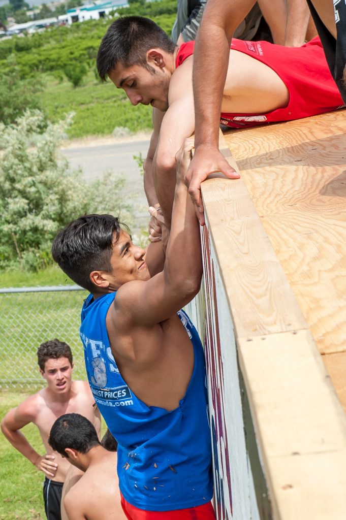 Students above and below the wall helped their teammates complete the climb. (Richard McGuire photo)