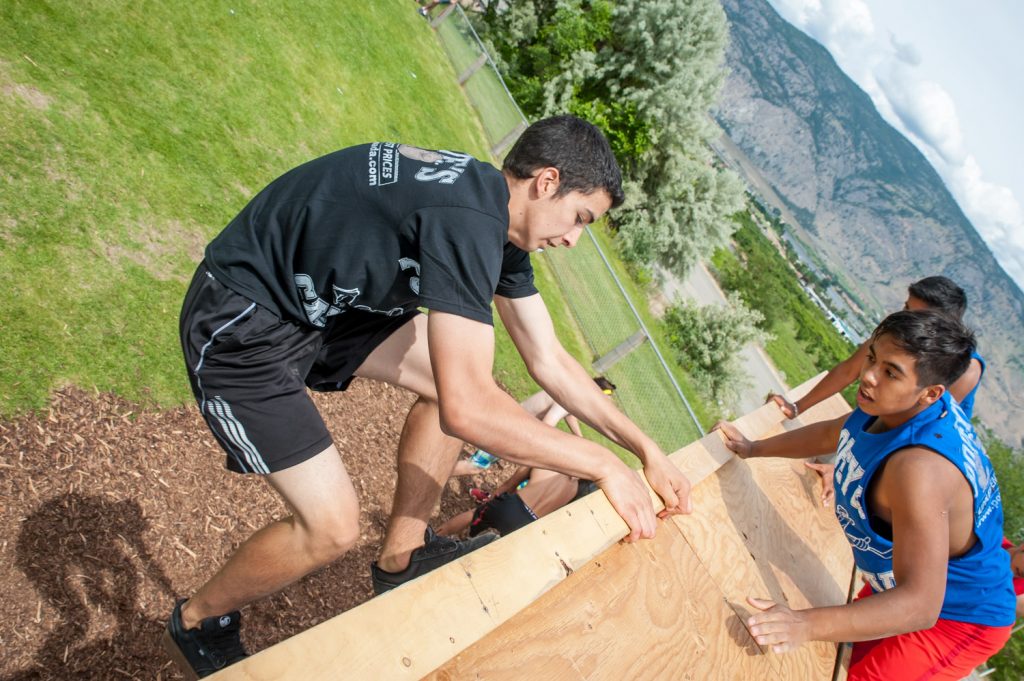 Students above and below the wall helped their teammates complete the climb. (Richard McGuire photo)