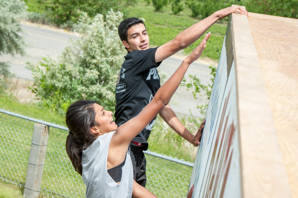 Students above and below the wall helped their teammates complete the climb. (Richard McGuire photo)