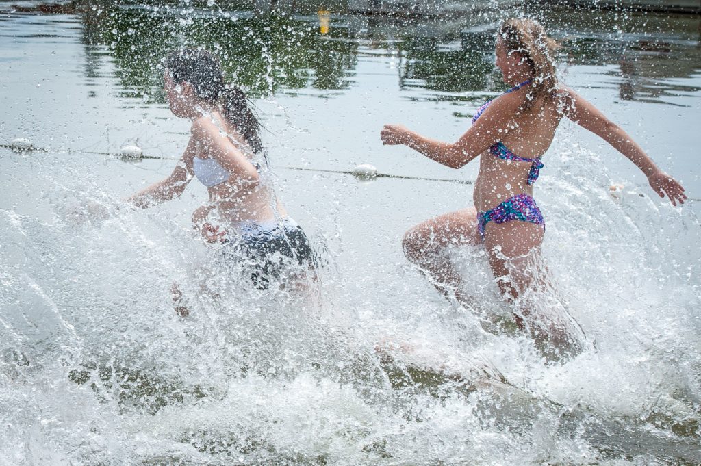 Angel Thomas and Johanne Jeffries kick up some water as they run in to do the swimming portion of the Storm the Wall relay. (Richard McGuire photo)