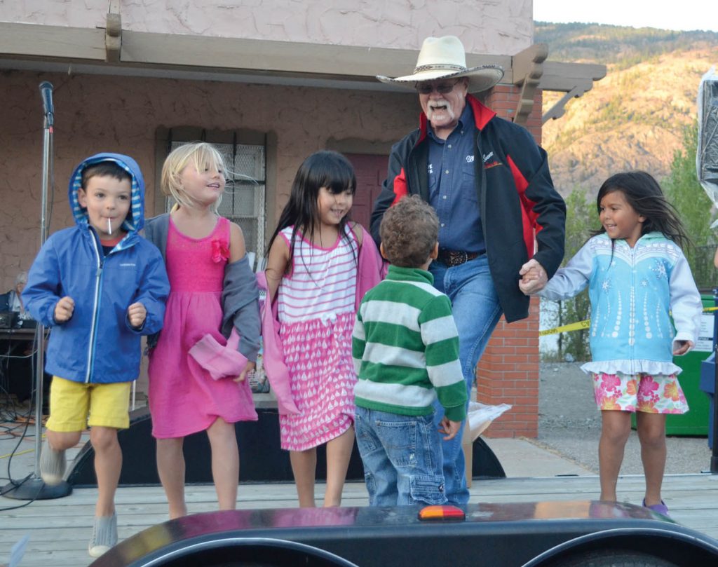 Clint Hawes entices a group of dancers on stage to kick up their heels. (Trevor Nichols photo)