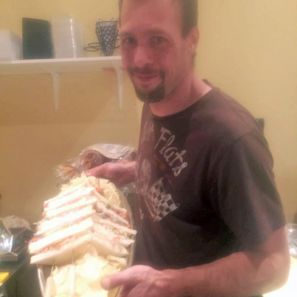 David Taylor serves a giant sandwich. He's apologizing to the individuals and businesses he hurt. (Selina S. photo)