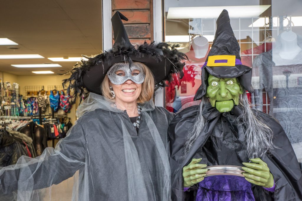 Which witch is which? Audrey Edwards (left) poses with Gretchen in front of Sonia's Boutique, where Edwards works. Gretchen's eyes lit up in red and her jaw moved as she cackled at passersby during Trick or Treat Main Street. (Richard McGuire photo)
