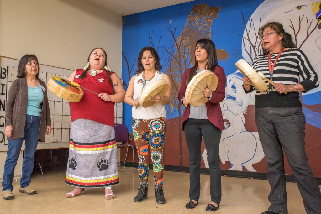Women from the Osoyoos Indian Band beat drums and sang during a break between speakers at the V-Day Oliver Osoyoos event Sunday at the Osoyoos Indian Band Community Hall in Oliver. (Richard McGuire photo)