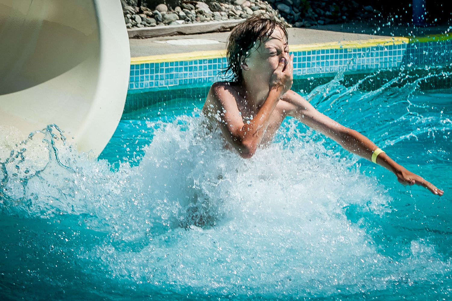 Ethan Kuzmak, 12, of Osoyoos braces for the water as he reaches the end of a waterslide at Osoyoos Campground and Waterslides. Kuzmak was visiting the slides off Lakeshore Drive with other children from Cactus Kids Club Day Camp. (Richard McGuire photo)