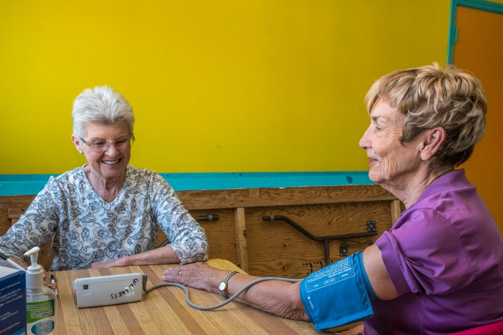 Retired nurse Alice Partridge (left) does a blood pressure check on Barbara Lodge last Thursday morning at the Cactus Centre. The Osoyoos Wellness Clinic resumed last Thursday and runs until April and is especially popular with snowbirds, who drop in for coffee, to socialize and get their blood pressure checked. The Cactus Centre is right behind the Osoyoos Splash Park. (Richard McGuire photo)