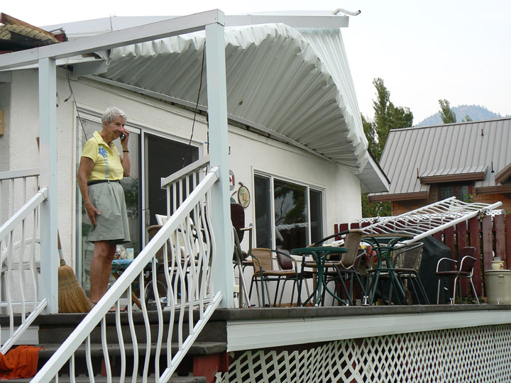 windweb Joyce Harvey stands amid the damage to her home’s deck several hours after a windstorm damaged it on Aug. 3. Photo by Lori Stodola - Click on picture for larger image