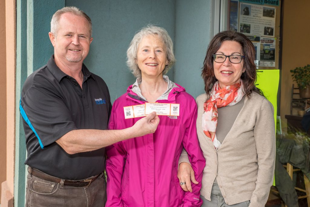 Osoyoos Times Editor Keith Lacey presents tickets for the Okanagan Zone Theatre Festival to Trish Murray (middle) and Liliana DeNardo, who were winners of a draw. (Richard McGuire photo)